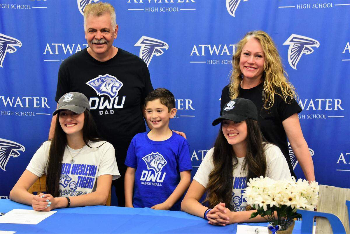 The Valencia family celebrated signing day for Lexi Valenica (front, left) and Kelsey Valencia (front, right). Father Gabriel, mother Esther and little brother Jordan pose for photos after the twins sisters signed their national letter of intent to accept a basketball scholarship to Dakota Wesleyan University on Tuesday, April 30, 2019 at Atwater High.