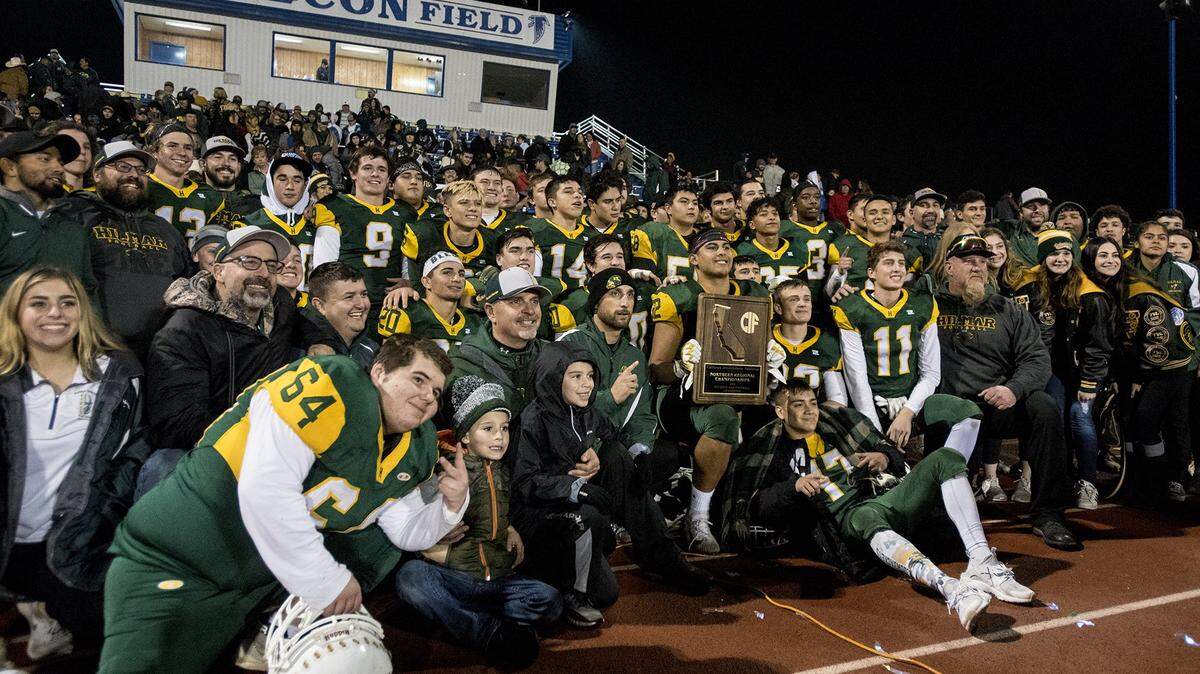 The Hilmar Yellowjackets pose for a team photo after a 48-14 win over East Nicolaus in the Northern California 6-AA Championship game at Atwater High School in Atwater, Calif., on Friday, Dec. 7, 2018.