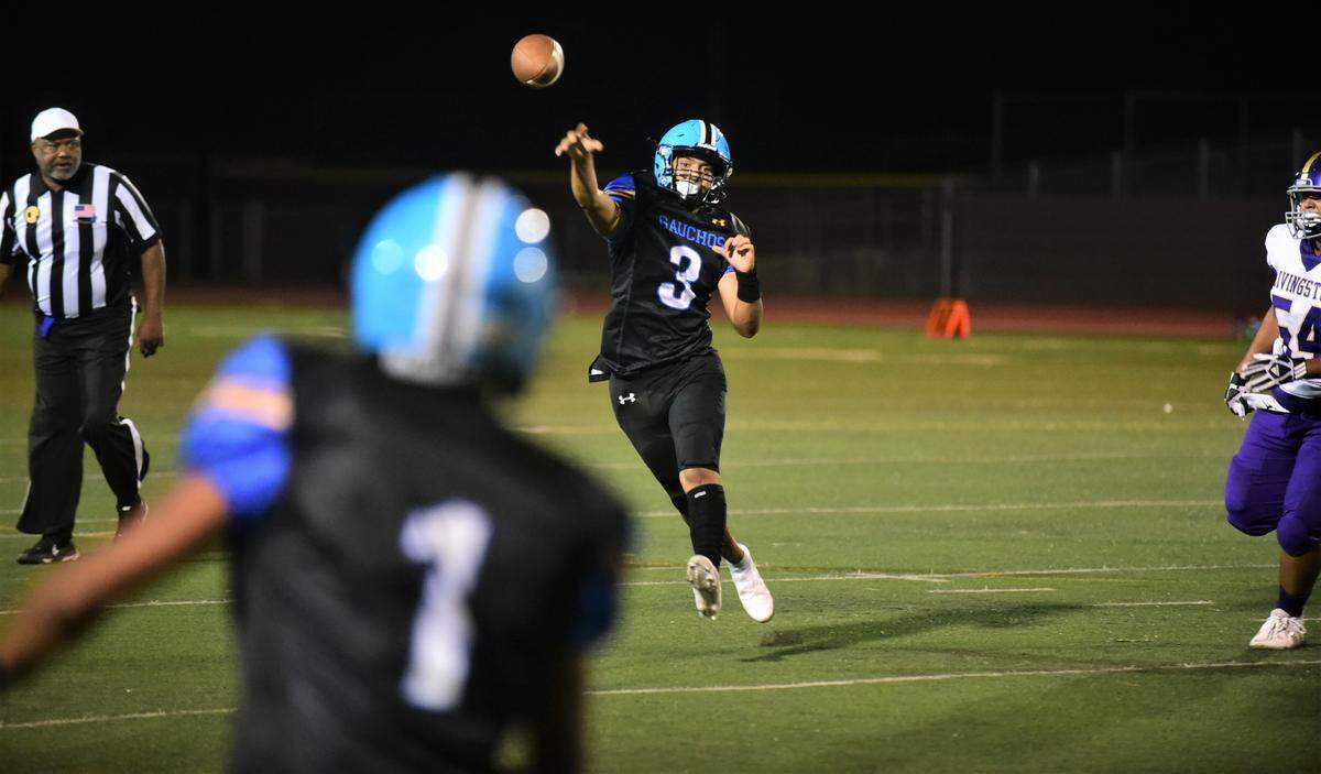 El Capitan High quarterback Ceaser Manzo throws a pass on the run against Livingston in the first half on Friday, Sept. 10, 2022.