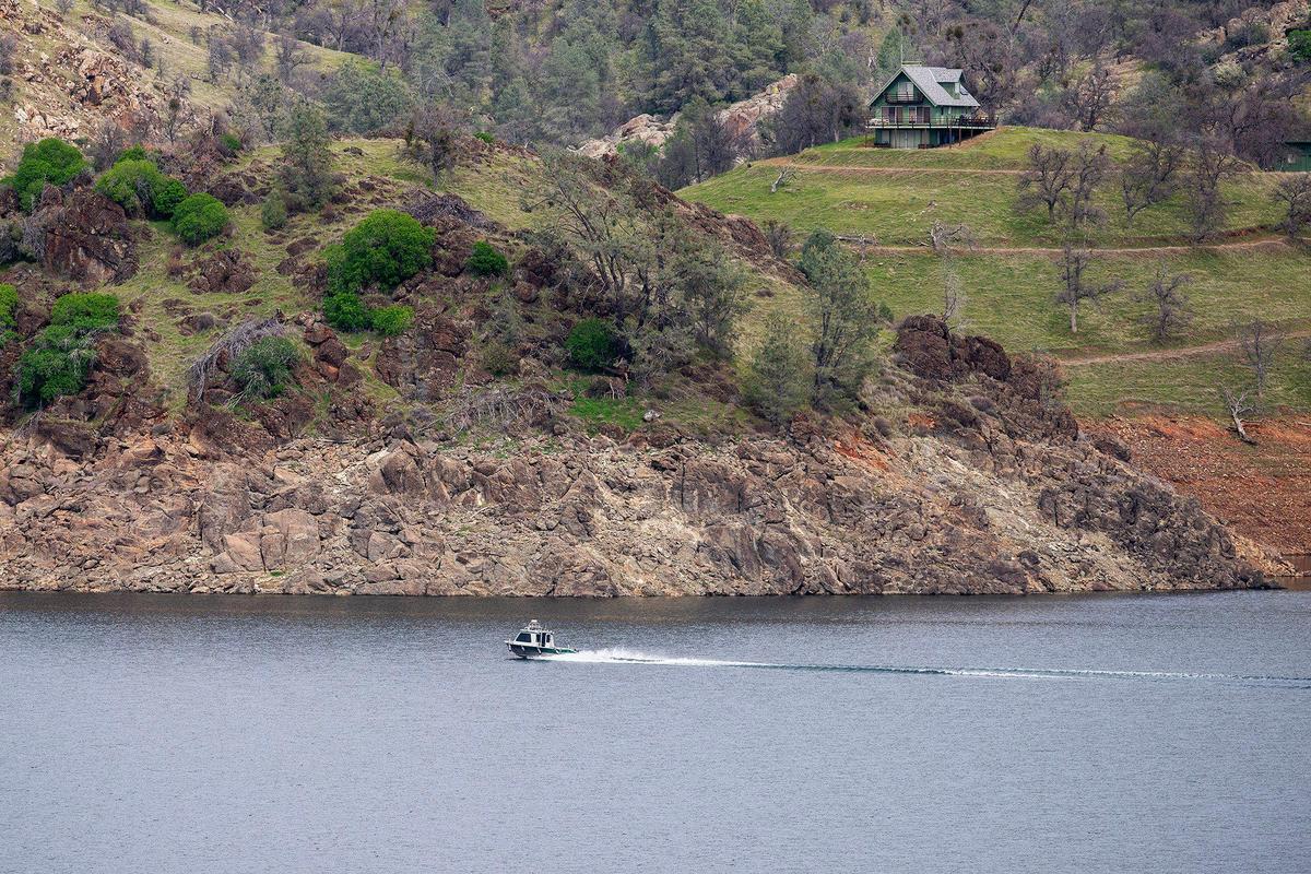A boat skips along the surface of the water at Lake McClure in Mariposa County, Calif., on Monday, Feb. 24, 2025.