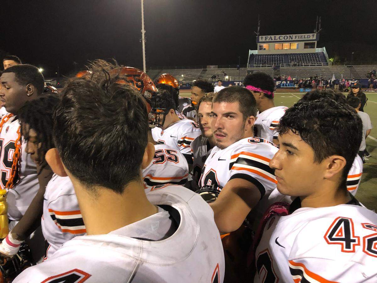 Merced High senior Bruce Smith (center) looks on as the team gathers after a 59-19 win over Atwater on Friday, Oct. 19, 2018 at Dave Honey Stadium in Atwater, Calif. Smith, who was the Bears team manager, saw his first action on the field as a player late in the game against the Falcons.
