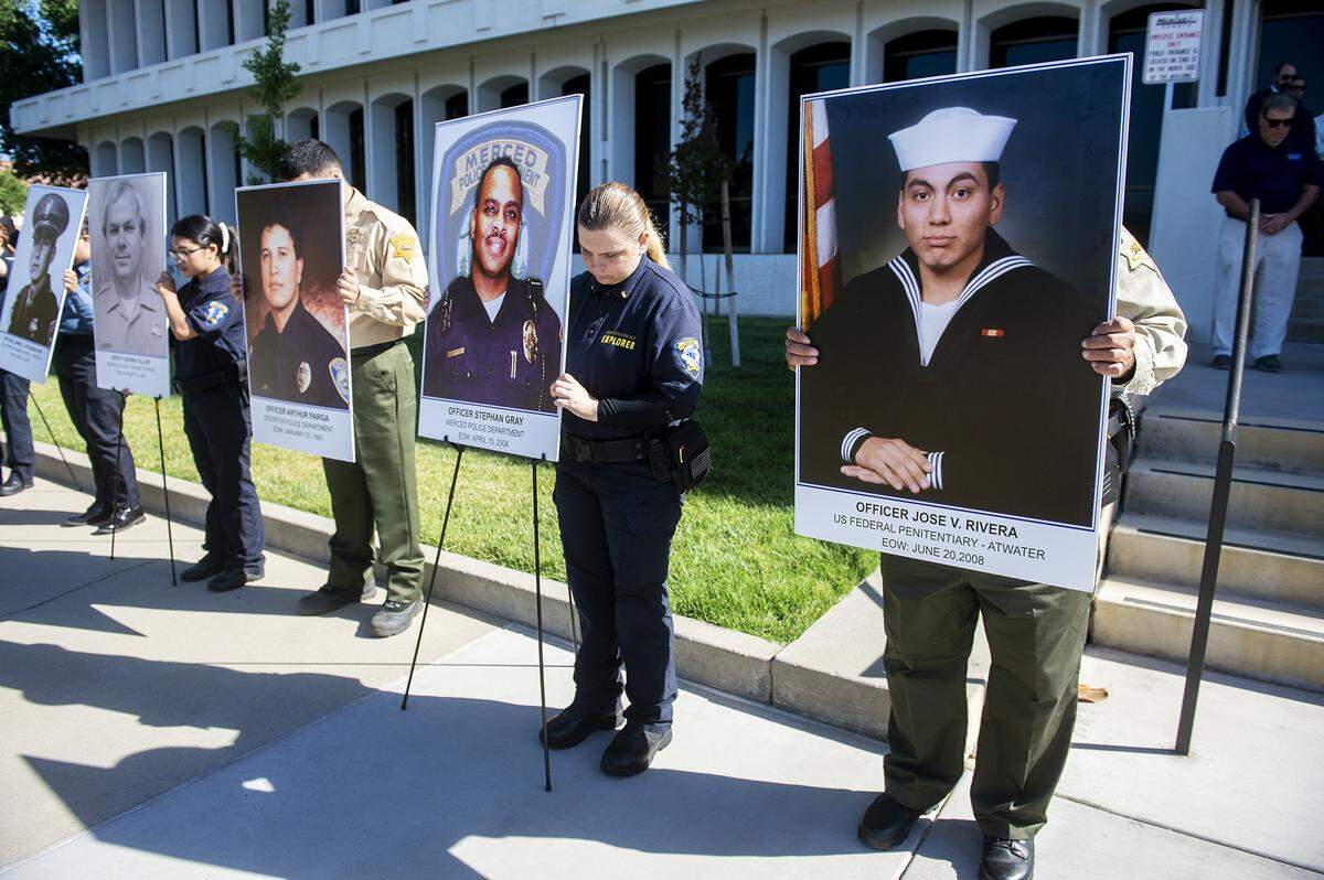 Images of fallen Merced County law enforcement officers are displayed during the annual Merced County Peace Officers Memorial Ceremony in Merced, Calif., on Wednesday, May 29, 2024. The ceremony honors law enforcement officers who died in the line of duty.