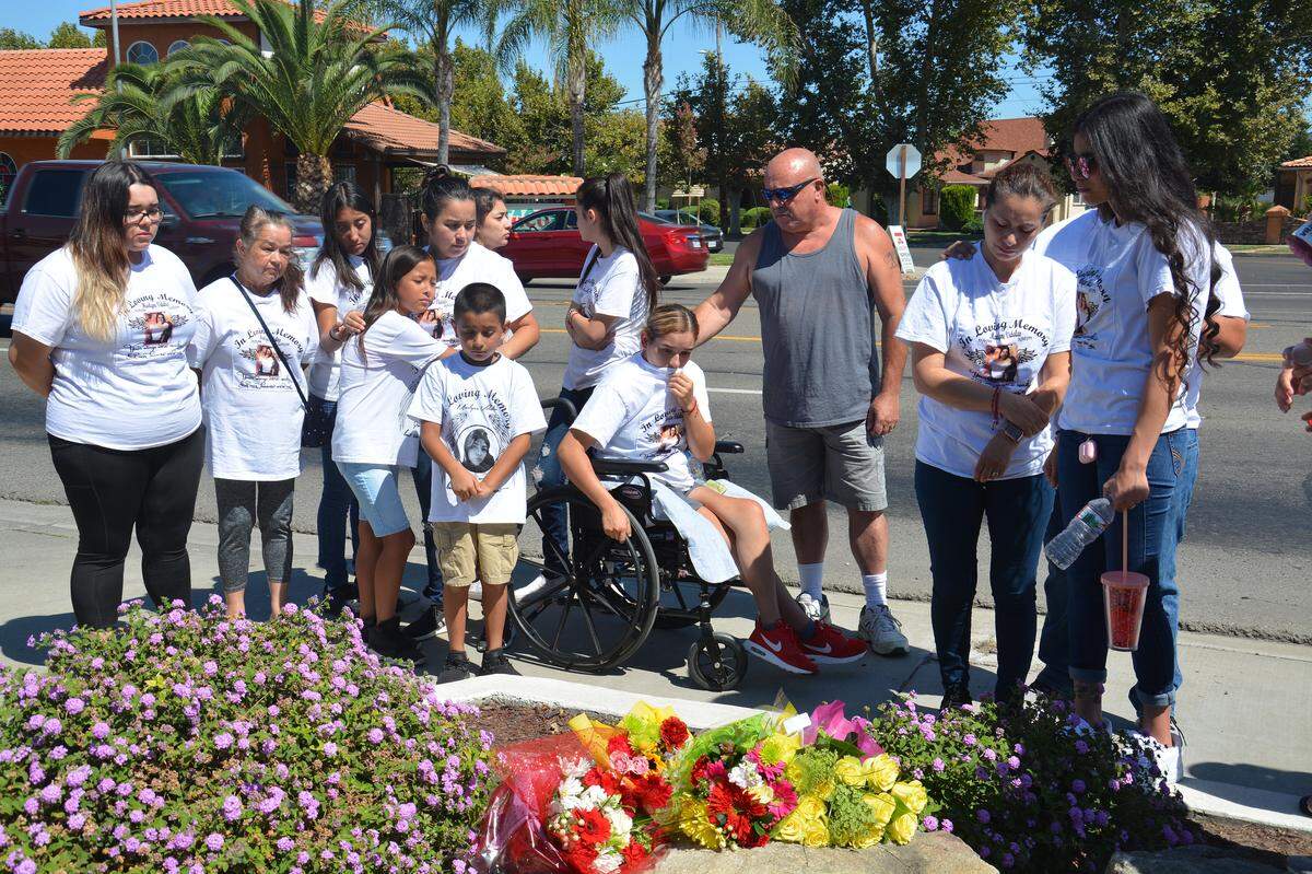 Madera 19-year-old Marlyne Vidales’ family gathers around a flower memorial they made after a July 31, 2019, court hearing on Ivan Andrade, a Los Banos man who is accused of driving 150 mph before he collided into a car on March 10, 2019, killing Vidales and severely injuring four others. Vidales’ family sets flowers at the spot Vidales was killed, the corner of 10th Street and Pacheco Boulevard in Los Banos, after every court hearing.