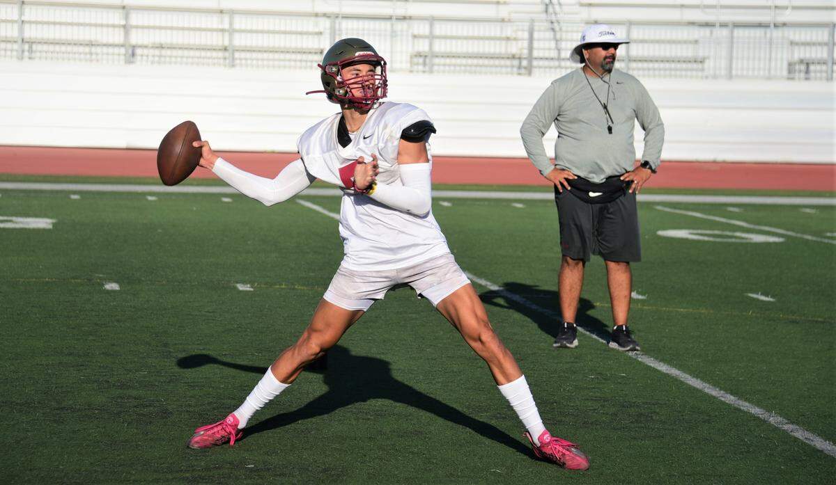 Golden Valley High School senior quarterback Eleazar Garza throws a pass during practice on Tuesday, Aug. 10, 2022 at Veterans Stadium in Merced, Calif.