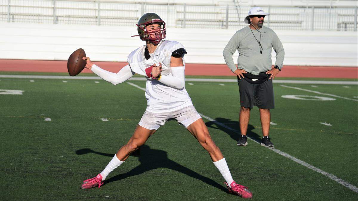 Golden Valley High School senior quarterback Eleazar Garza throws a pass during practice on Tuesday, Aug. 10, 2022 at Veterans Stadium in Merced, Calif.