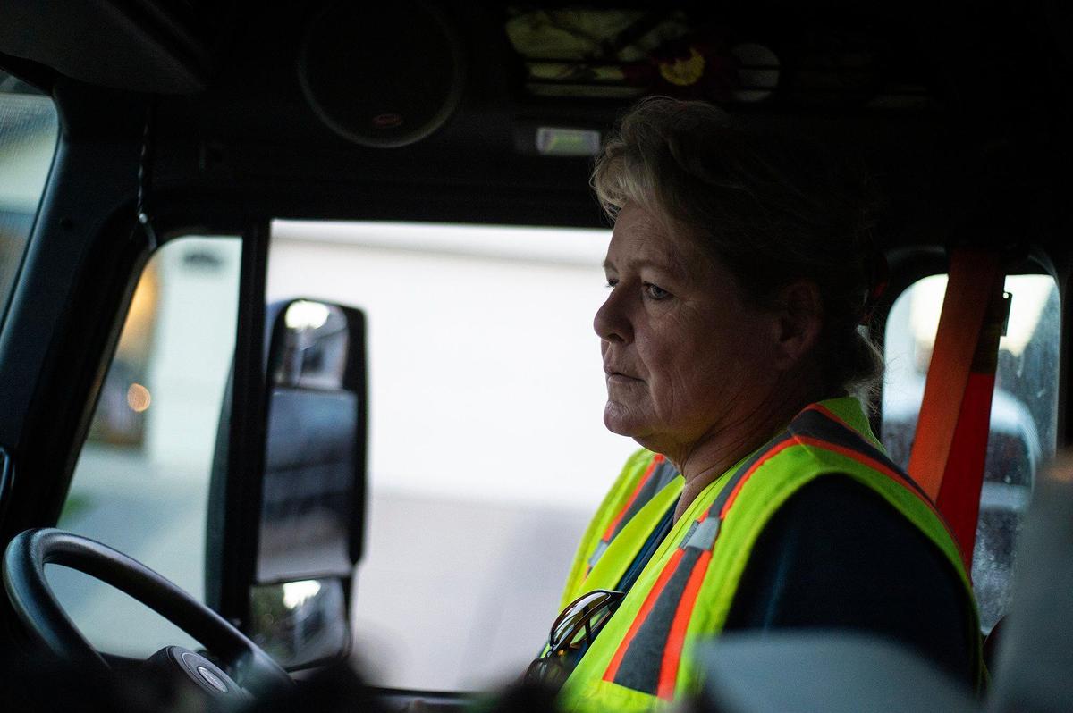 Merced Refuse Equipment Operator Kristie Light, 56, drives her route collecting refuse in Merced Calif. on Thursday, Oct. 24, 2024. According to Light who previously drove commercial trucks across parts of the country and would routinely be gone for 70-80 hours a week, her current job with the city allows her to spend more time at home. “It’s nice to go to work and like your job,” said Light.