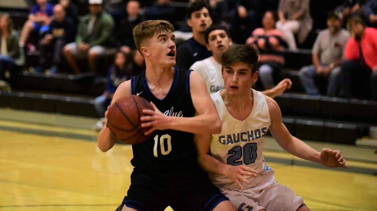 Despite a bloody nose, Atwater freshman Tyler Parr goes up for a shot against El Capitan freshman Brody Collins during a game on Wednesday, Jan. 15, 2020.