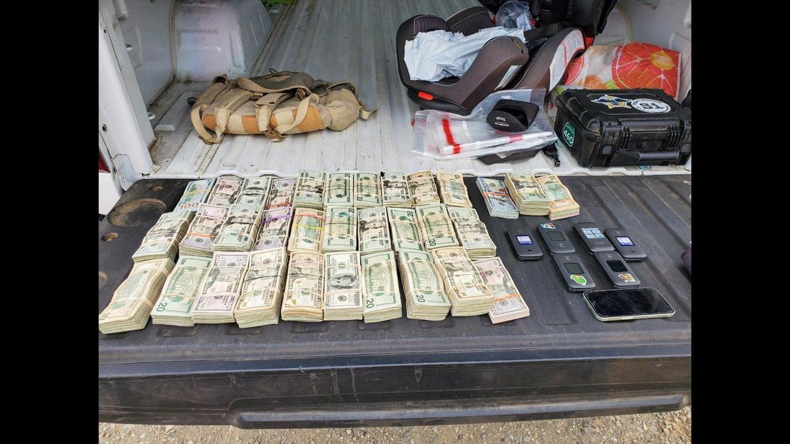 California Highway Patrol officers and CHP K-9 Beny and Bruce, located hundreds of thousands of dollars in suspected drug money between two separate traffic stops on Interstate 5 in Fresno County on Oct. 22, according to the CHP. Officers found about $300,000 during one traffic stop and $179,880 during the other. Image courtesy of California Highway Patrol.