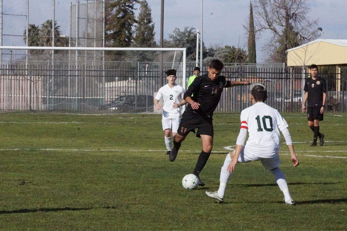 Livingston High’s Estevan Moreno (11) clears the ball against Liberty Ranch. The Wolves won the Sac-Joaquin Section Division IV semifinal match 2-0. Photo courtesy of Scott Winton.