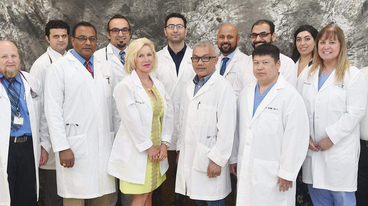 Dr. Karthikeya Devireddy, fourth from left, stands with his fellow providers at Apex Medical Group.