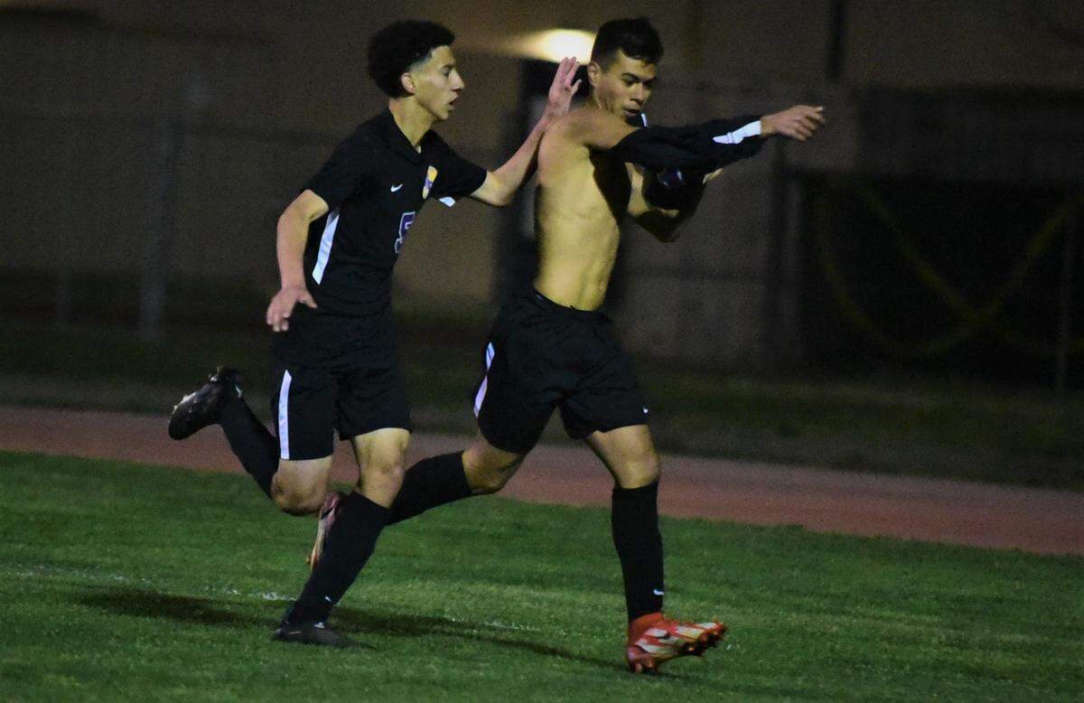 Livingston High junior Ezekiel Padilla takes off his jersey while celebrating a goal against Dixon during a playoff match on Tuesday, Feb. 15, 2022 in Livingston, Calif.