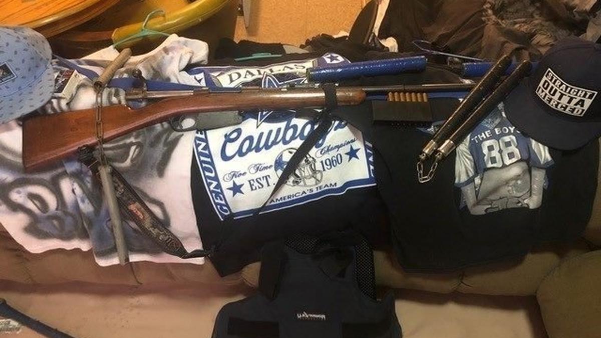 A rifle, ammunition and nunchucks police say they found while executing a search warrant at the home of 27-year-old alleged gang member and convicted felon, Luis Ibarra, in Merced on Thursday. Photo courtesy of the Merced Police Department.
