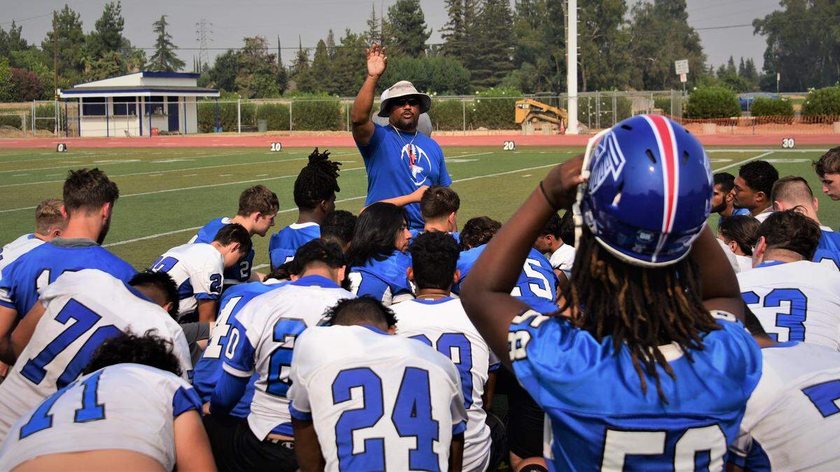 Atwater High football coach Seneca Ybarra talks to the players after practice on Thursday, Aug. 19, 2021.