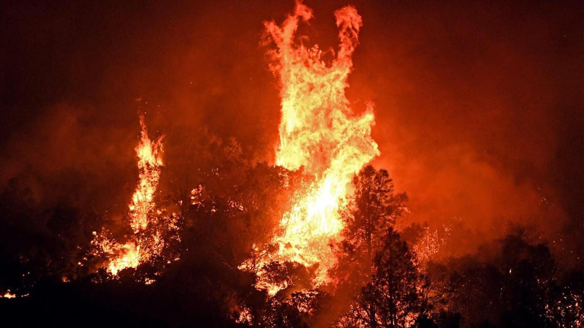 High winds cause tree canopies to flare up at the Oak Fire as it burns east of Midpines Friday night, July 22, 2022 near Mariposa.