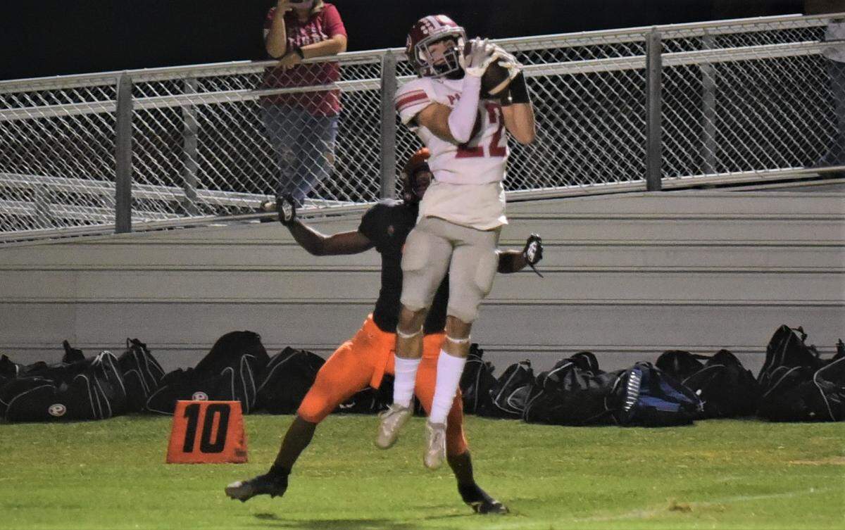 Patterson High senior Austin Lucas (22) goes up high for a catch against Merced High junior Chase Smith during a game on Friday, Sept. 23, 2022 at Merced High School.