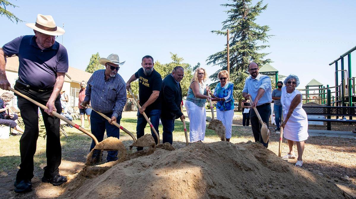 Community members and local dignitaries break ground during a ceremony for a remodel project at Houlihan Park in Planada, Calif., on Monday, Aug. 2, 2021. In February 2020, Merced County was notified that it would be awarded $2,451,250 in funds from the Proposition 68 grant. The project will install new amenities at the roughly four acre park which include a new splash pad, outdoor stage, jogging path, resurfaced basketball court, pavilions and barbecues among several others.