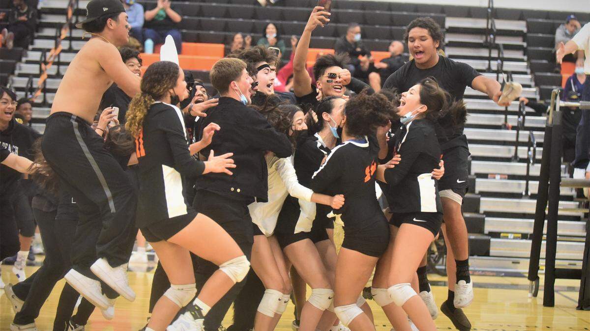 The Merced High student section stormed the court to celebrate the Bears volleyball team’s dramatic 3-2 win over Buhach Colony on Tuesday, Oct. 19, 2021 at Merced High School.