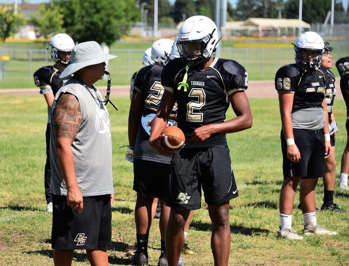 Buhach Colony senior Trey Paster (2) talks with Thunder head coach Kevin Navarra during a practice this summer.