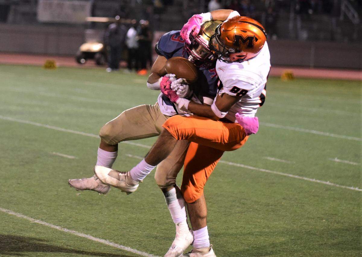 Merced High receiver Jeremiah Folau (88) battles Golden Valley defender Ethain Vang (9) for a pass during the Battle for the Mayor’s Cup on Friday, Oct. 28, 2022. Merced defeated Golden Valley 31-6.