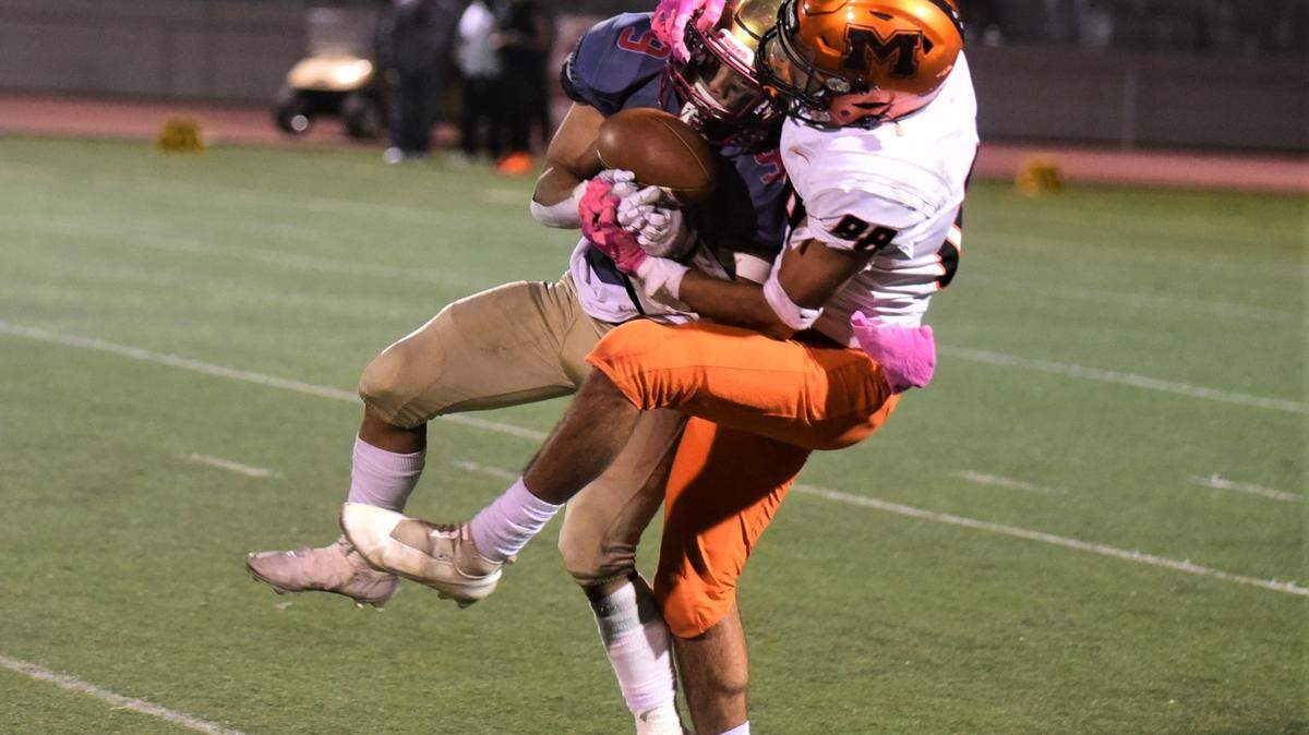 Merced High receiver Jeremiah Folau (88) battles Golden Valley defender Ethain Vang (9) for a pass during the Battle for the Mayor’s Cup on Friday, Oct. 28, 2022. Merced defeated Golden Valley 31-6.