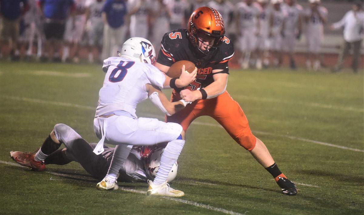 Merced High quarterback Seth Scheidt (5) delivers a blow to East Union defender Rafael Espinoza (8) during the Bears’ 56-15 win in the second round of the Sac-Joaquin Section Division IV playoffs on Friday, Nov. 12. 2021 at Veterans Stadium in Merced, Calif.