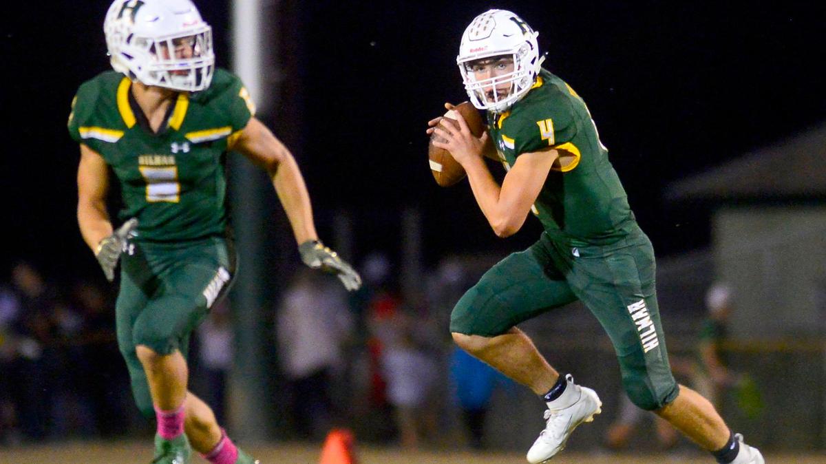 Hilmar quarterback Seth Miguel (4) rolls to his left during a game between Hilmar High School and Escalon High School at Hilmar High School in Hilmar California on September 20, 2019.