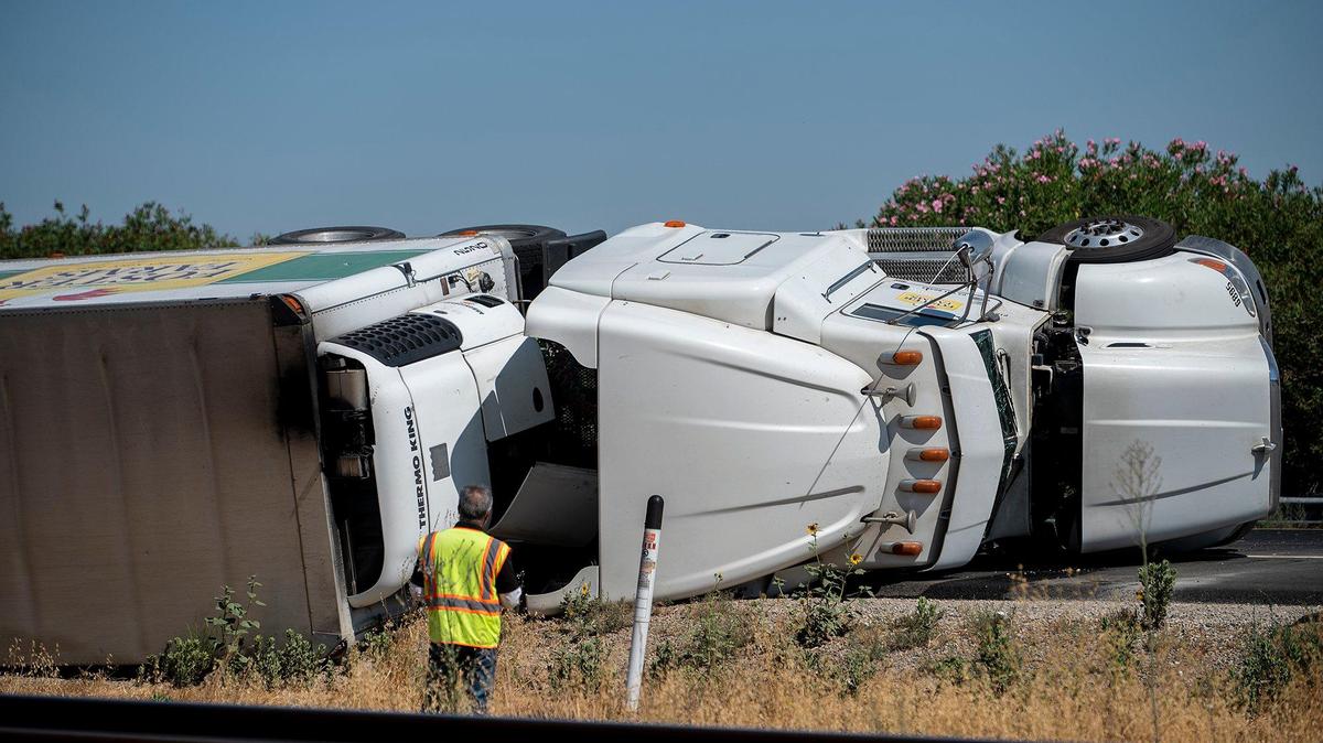 A crash involving an overturned Foster Farms big rig slows traffic along southbound Highway 99 just north of Franklin Road in Merced County, Calif., on Wednesday, Aug. 23, 2023. According to the California Highway Patrol, the driver of the truck was not injured.