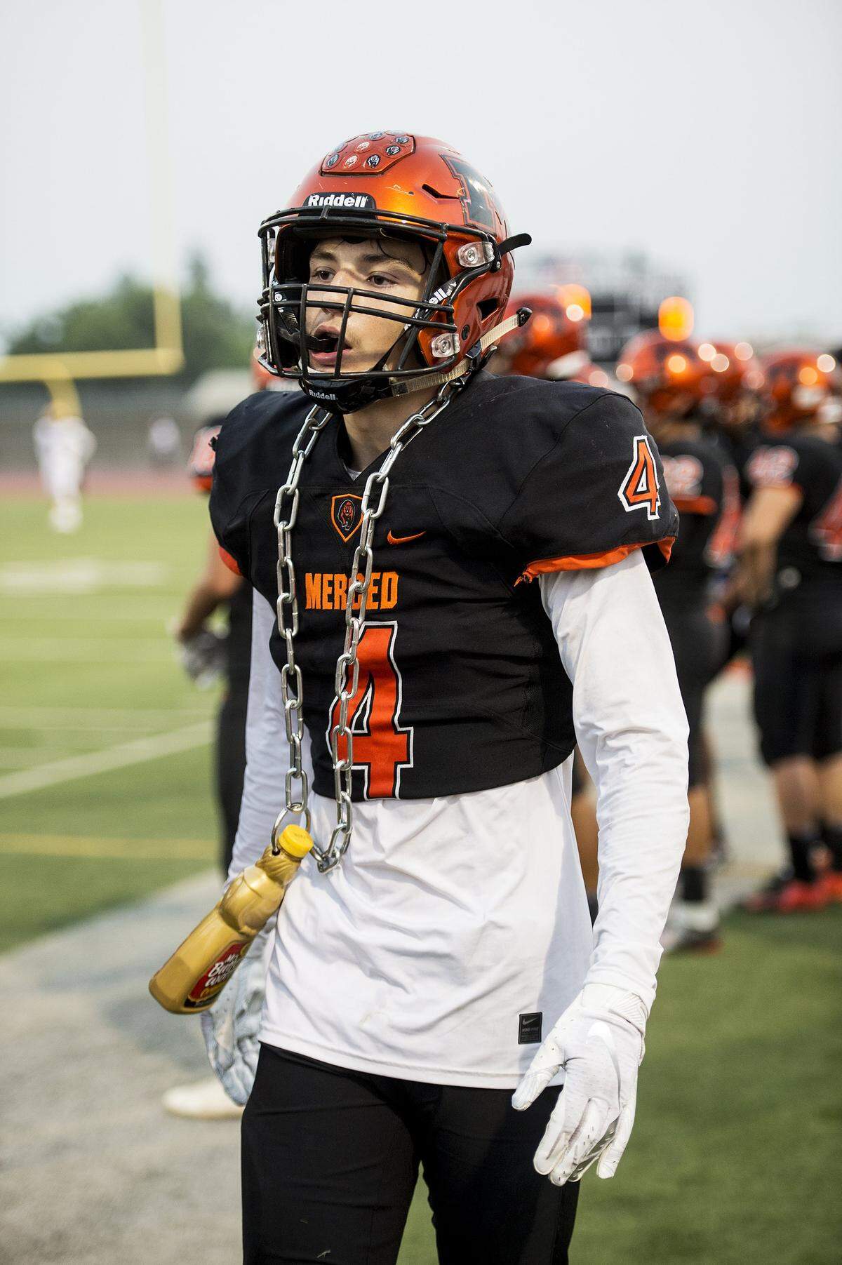 Merced senior Ezra Morales (4) wears the “Pancake Chain” while walking the sideline during a game against Gregori at Veterans Stadium on the campus of Golden Valley High School in Merced, Calif., on Friday, Aug. 24, 2018. The Bears beat the Jaguars 41-22.