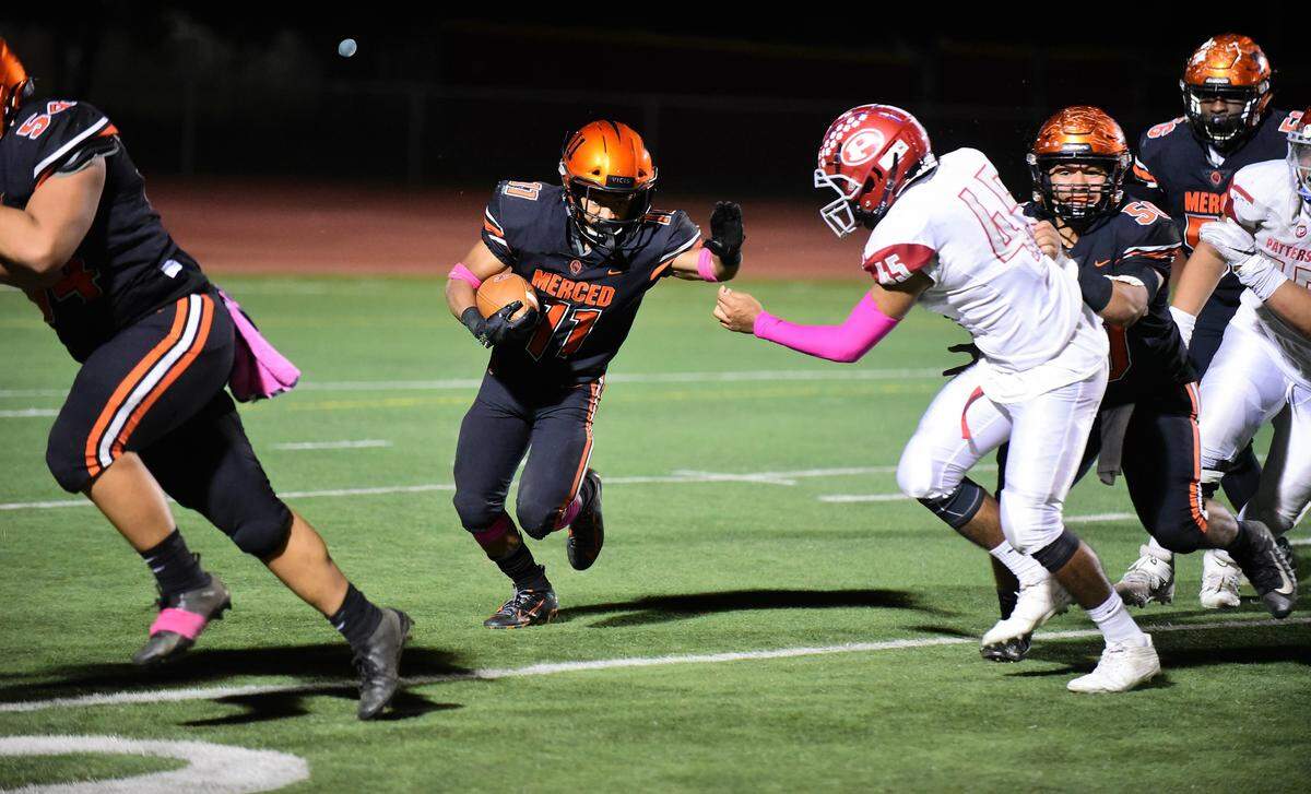 Merced High senior running back Desmond Thompson makes his way through the hole against Patterson. Thompson scored three touchdowns in a 54-24 win for Merced on Friday, Oct. 18, 2019 at Veterans Stadium.