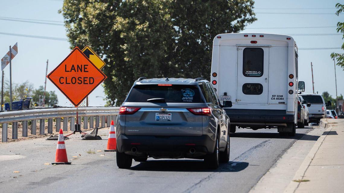 Motorists navigate a lane closure on the Bear Creek Bridge near the intersection of West 16th Street and Highway 59 in Merced, Calif., on Friday, July 18, 2025. A lane of the bridge has been closed in each direction as crews work to complete a California Department of Transportation seismic retrofit project in Merced County.