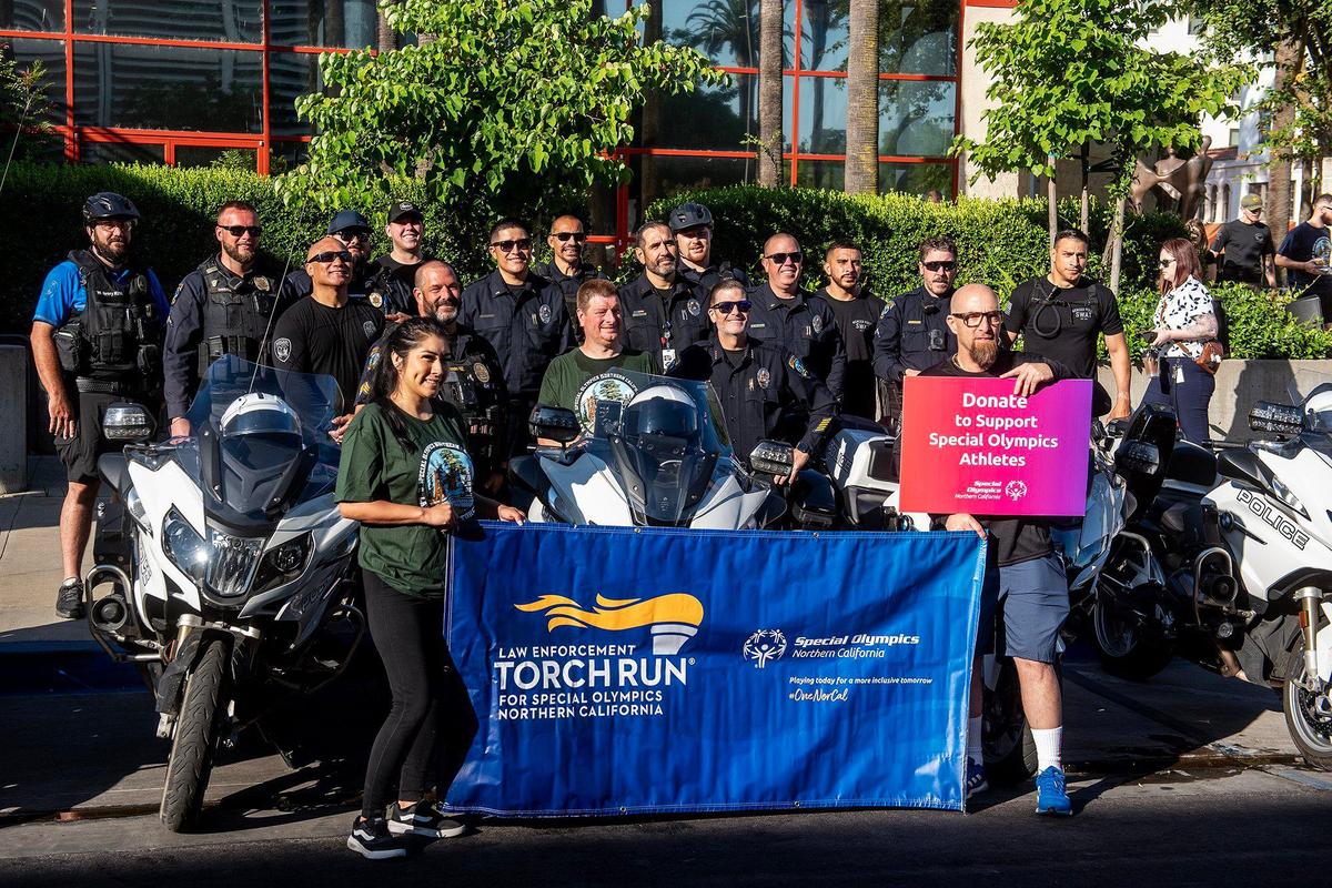 Participants gather for photos following the annual Law Enforcement Torch Run for Special Olympics Northern California in Merced, Calif., on Wednesday, June 25, 2025.