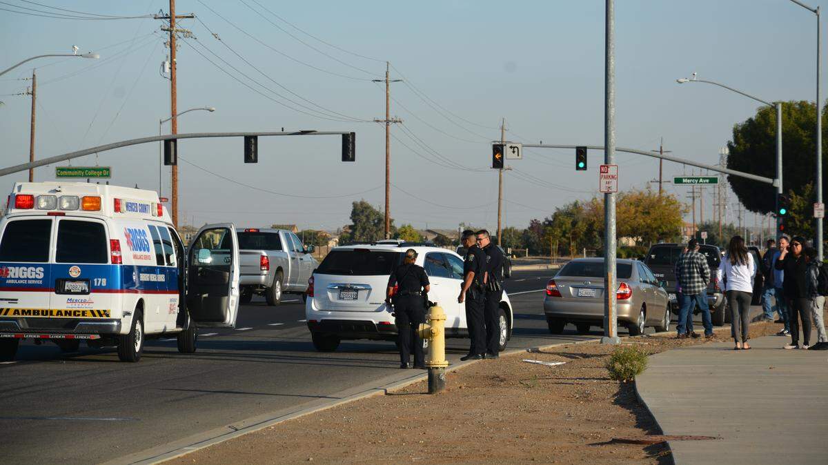Police direct the scene of a collision after a 26-year-old woman was hit by a vehicle while riding a bicycle near Mercy Medical Center in Merced. She suffered head trauma, but is expected to recover, police said.