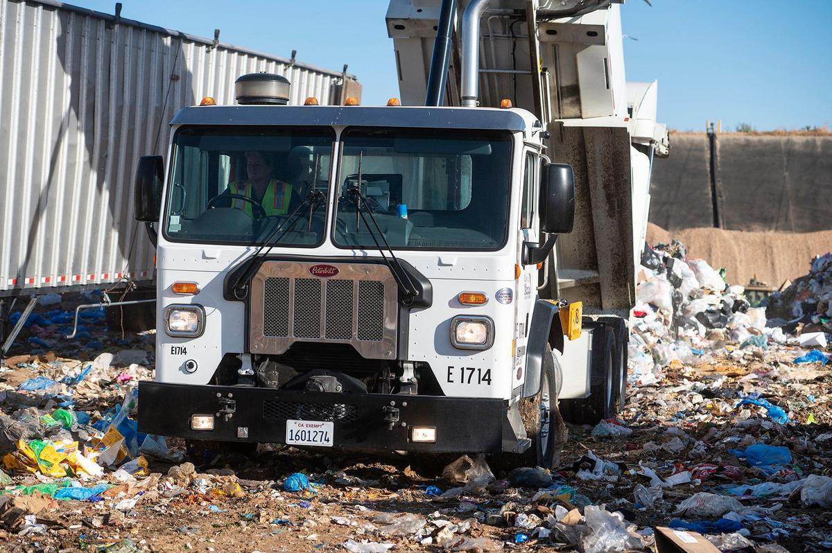 Merced Refuse Equipment Operator Kristie Light, 56, empties refuse from the truck at the landfill in Merced Calif. on Thursday, Oct. 24, 2024. According to Light who previously drove commercial trucks across parts of the country and would routinely be gone for 70-80 hours a week, her current job with the city allows her to spend more time at home. “It’s nice to go to work and like your job,” said Light.