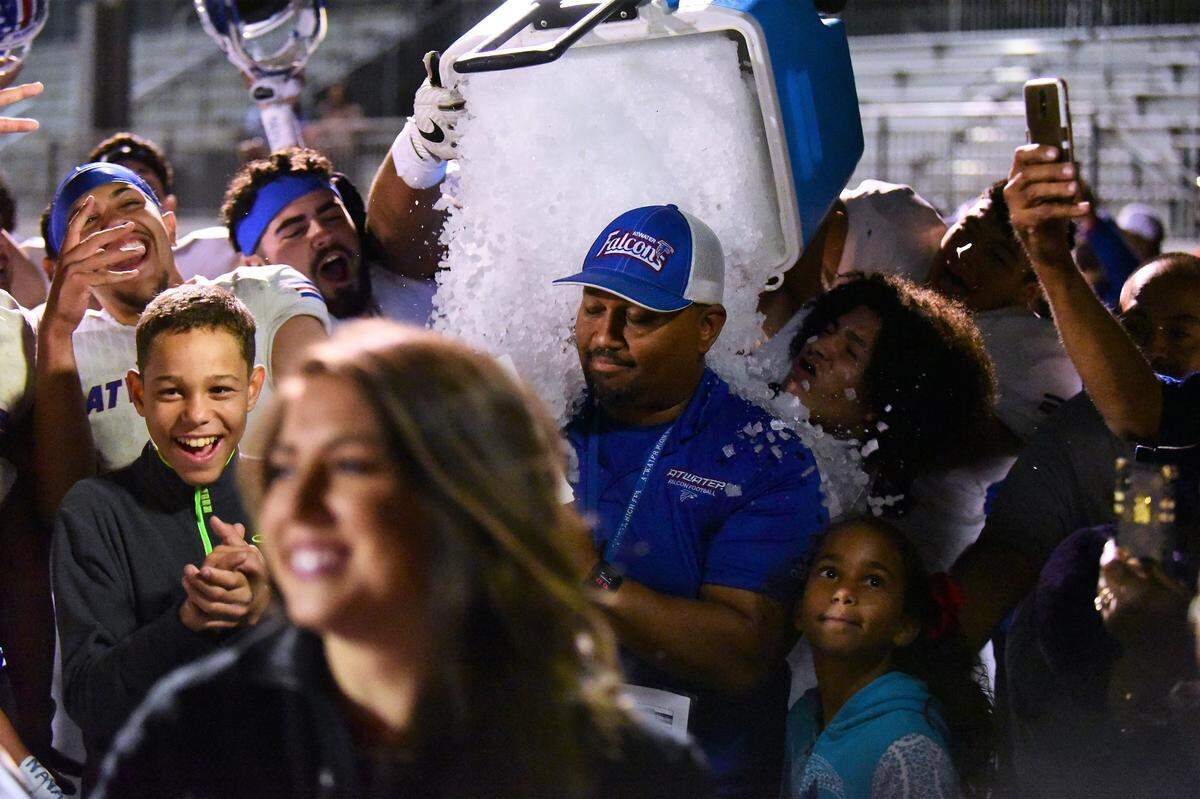 Atwater High football players dump an ice bucket on Falcons head coach Seneca Ybarra after Atwater’s 42-39 win in the 50th Santa Fe Bowl. The victory snapped a nine-game losing streak to Merced.