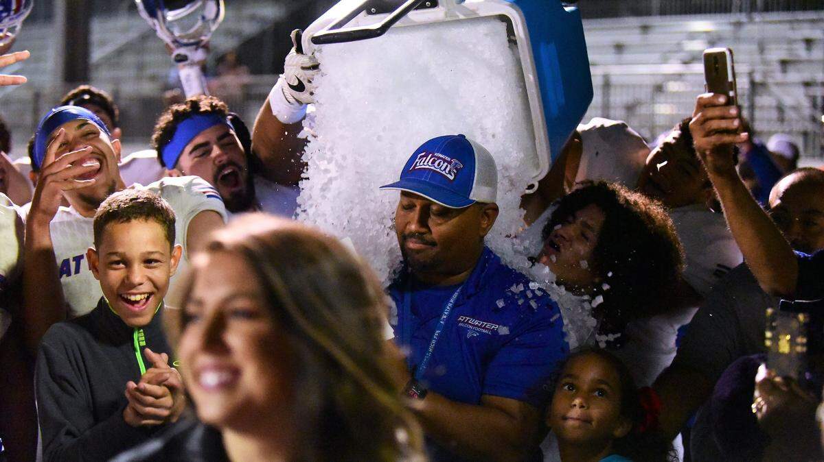 Atwater High football players dump an ice bucket on Falcons head coach Seneca Ybarra after Atwater’s 42-39 win in the 50th Santa Fe Bowl. The victory snapped a nine-game losing streak to Merced.