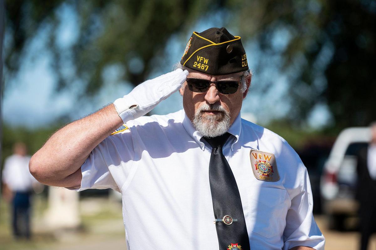 A member of V.F.W. Post 2487 salutes while honoring service members during a Memorial Day ceremony at the Los Banos Cemetery, located at 16575 Center Avenue in Los Banos, Calif., on Monday, May 30, 2022.