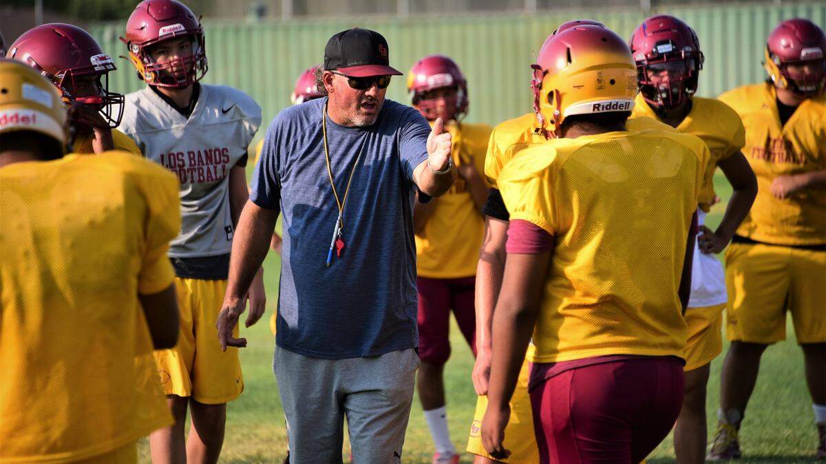Los Banos High School football coach Dustin Caropreso talks to his offense during practice on Thursday, Aug. 12, 2021.