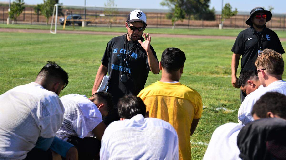 El Capitan High School first-year coach Anthony Martinez speaks to his players during practice on Thursday, Aug. 11, 2022 at El Capitan High School in Merced, Calif.