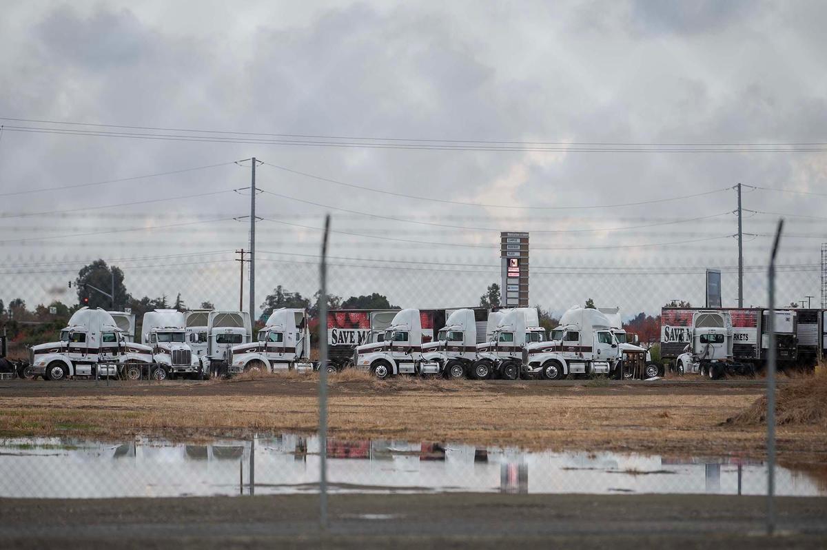 Trucks and trailers sit outside the now closed Yosemite Wholesale Distribution Center located at 2674 Vassar Ave. in Merced, Calif., on Tuesday, Nov. 26, 2024. The Save Mart Companies announced the planned closure of the facility in September.
