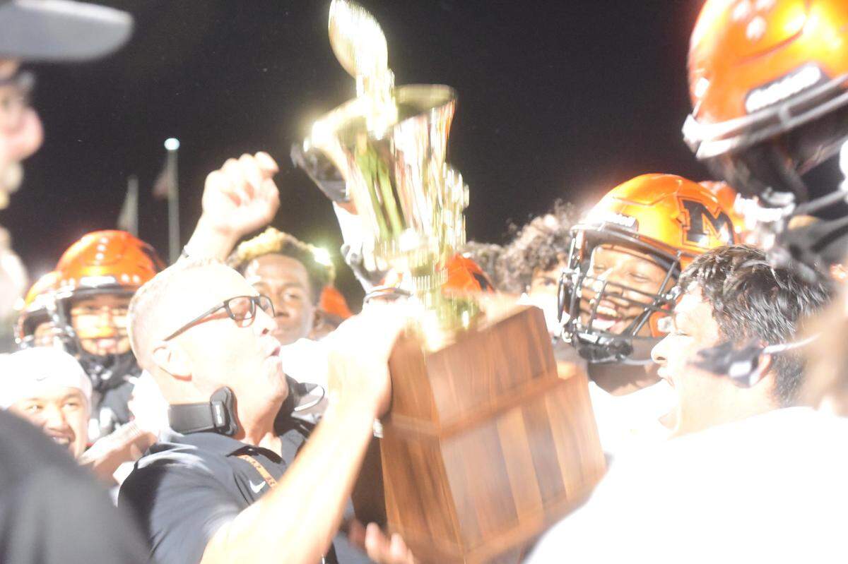 Merced High football head coach Rob Scheidt hoists the Mayor’s Cup trophy after the Bears’ defeated Golden Valley 32-8 on Friday, Oct. 4, 2024 at Veterans Stadium.