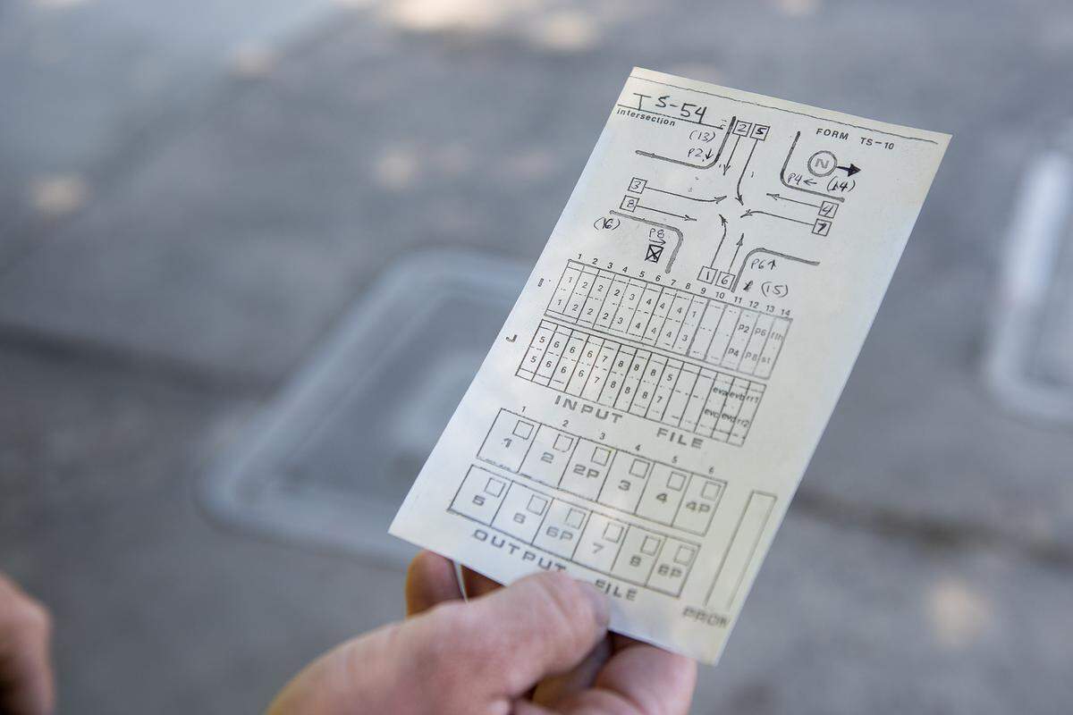 Tanner Harkreader, 28, a lead lighting technician with the City of Merced, holds a diagram of an intersection and wiring channels in Merced, Calif., on Thursday, July 31, 2025. 