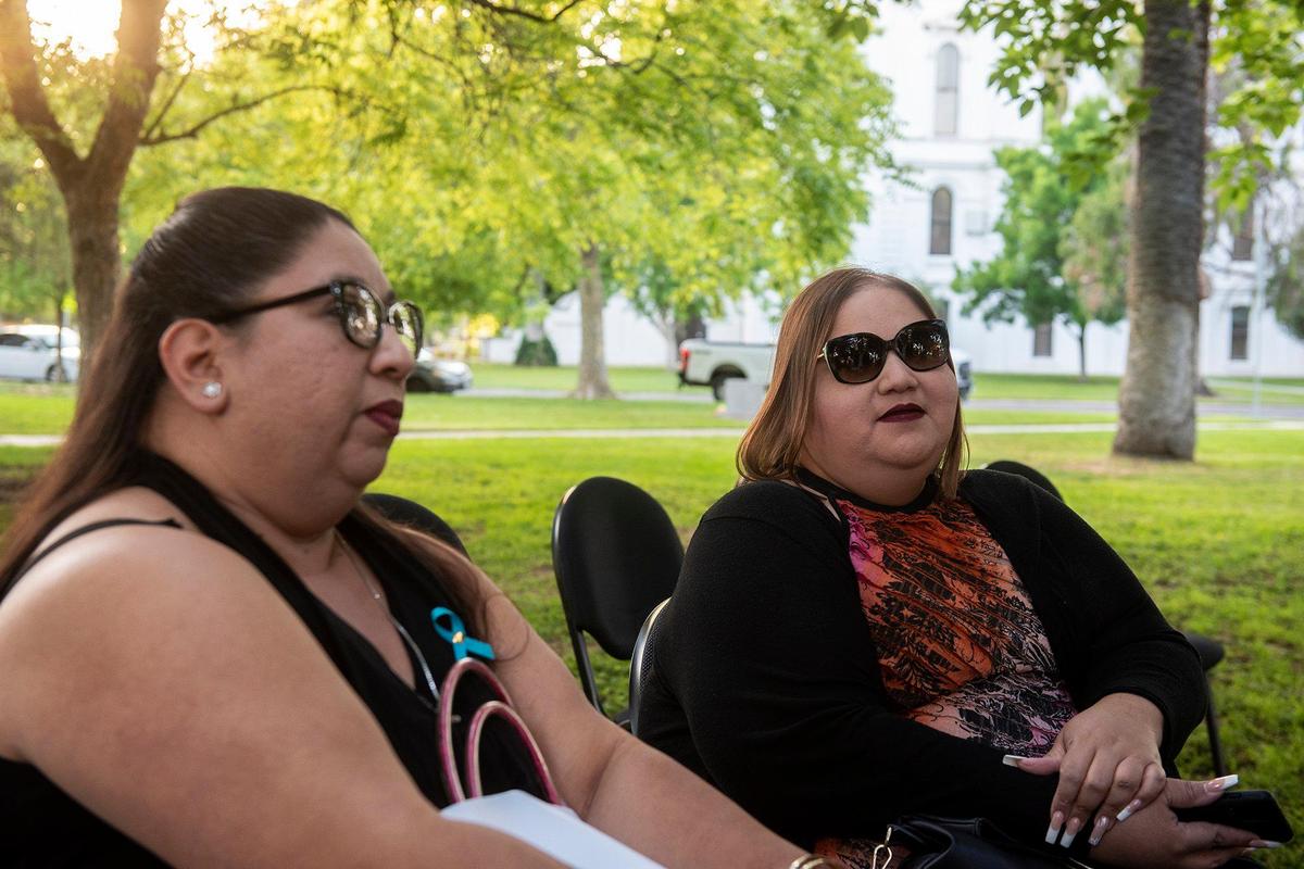 Deborah Marquez, left, and sister Alexandria Marquez, right, speak about their father David Marquez who was murdered in 2002, during the annual Victims’ Rights Ceremony at Courthouse Park in Merced, Calif., on Tuesday, April 26, 2022.