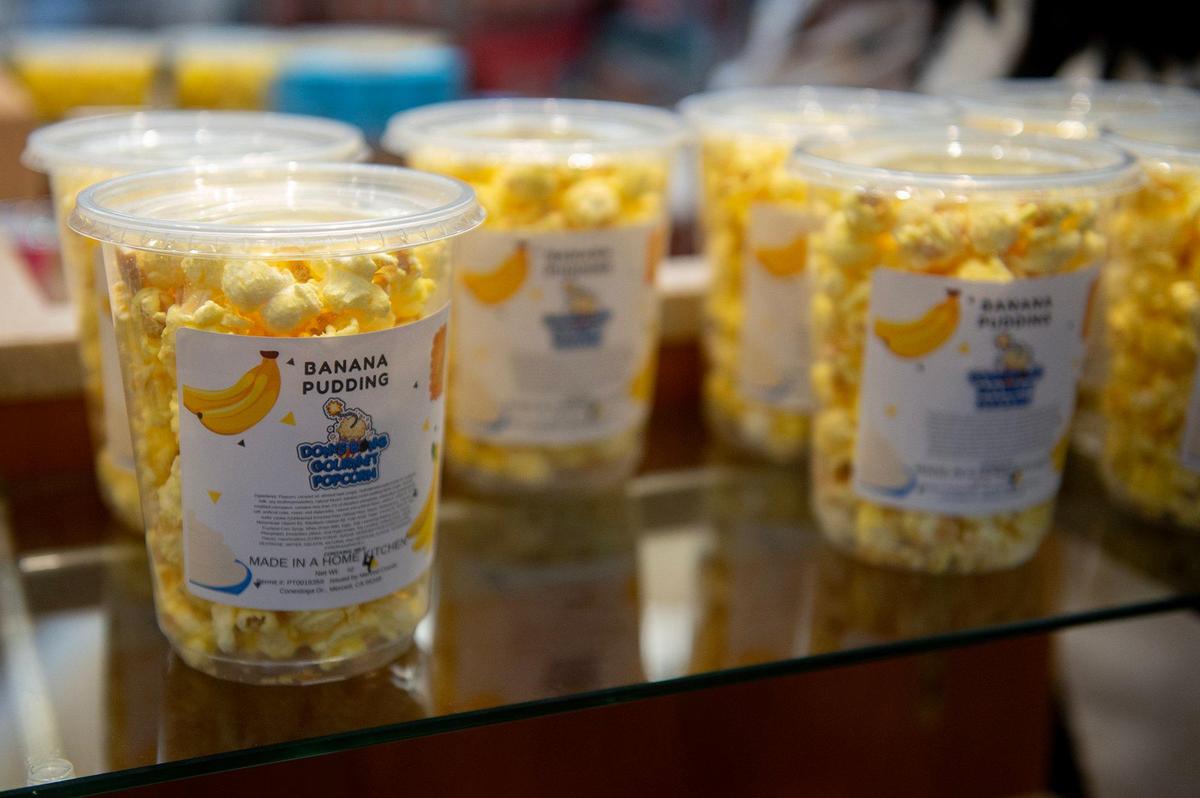 Various flavors of popcorn for sale during the grand opening of Dom’s Bomb Gourmet Popcorn inside the Marketplace at Merced in Merced, Calif., on Thursday, May 1, 2025. The kiosk offers unique gourmet popcorn flavors created by Merced resident Dominique Pruitt.