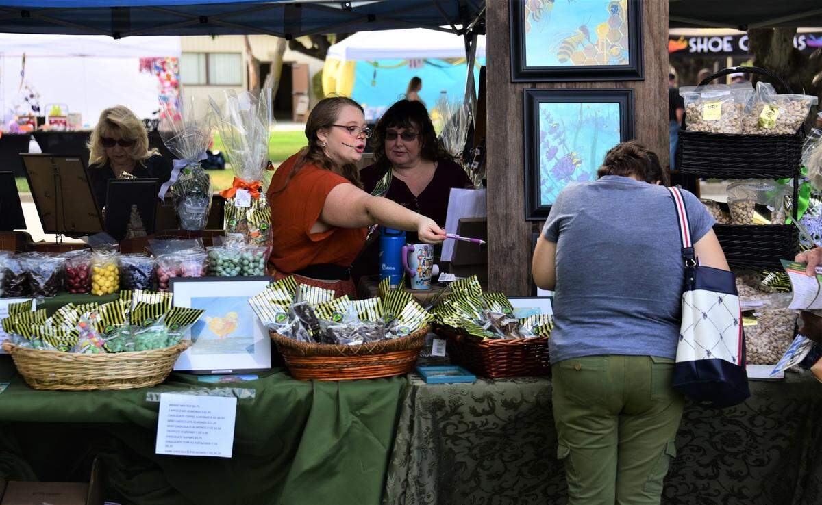 People shop at the Buchanan Hollow Nut Co. booth at the Merced County Nut Festival on Saturday, Oct. 22, 2022 at the Merced County Fairgrounds.