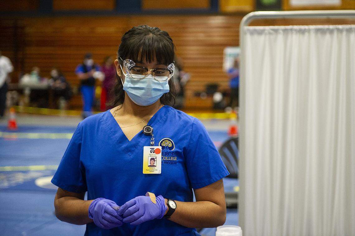 Merced College nursing student Kimberly Zotea waits for a patient as she works to administer a COVID-19 vaccines at a vaccination clinic inside a Merced College gymnasium in Merced, Calif., on Wednesday, Feb. 17, 2021.