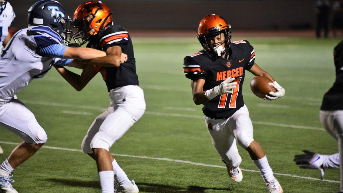 Merced senior running back Desmond Thompson, shown here earlier this season against Downey, scored three rushing touchdowns and added another score with a pass, to lead the Bears to a 33-7 win over Golden Valley.