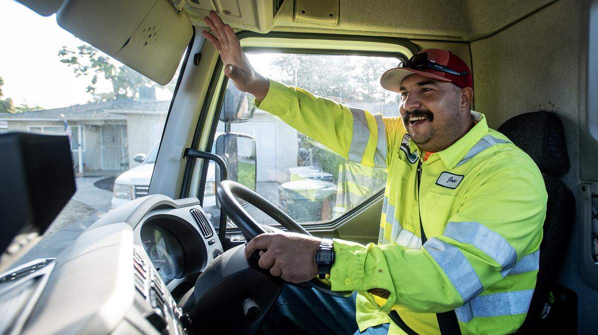 Jose Lopez, 34, waves to a resident while operating one of the city’s sweeper trucks in Merced, Calif., on Thursday, Sept. 11, 2025. Having developed a fascination with trucks and machinery as a child, Lopez said he is living his dream driving and operating the city’s various trucks and machinery.