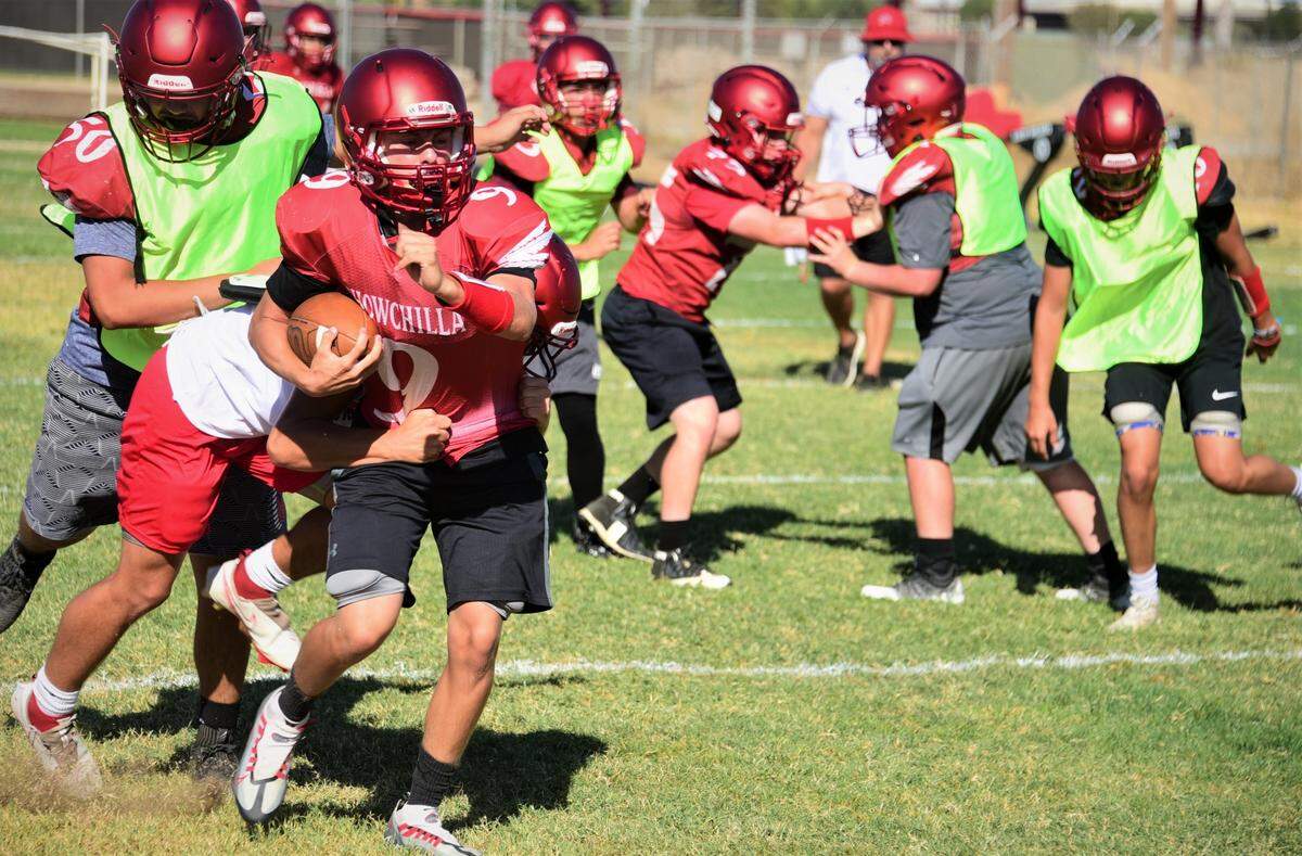 Chowchilla High School sophomore Frankie Fuentes runs the ball during practice on Wednesday, Aug. 10, 2022.