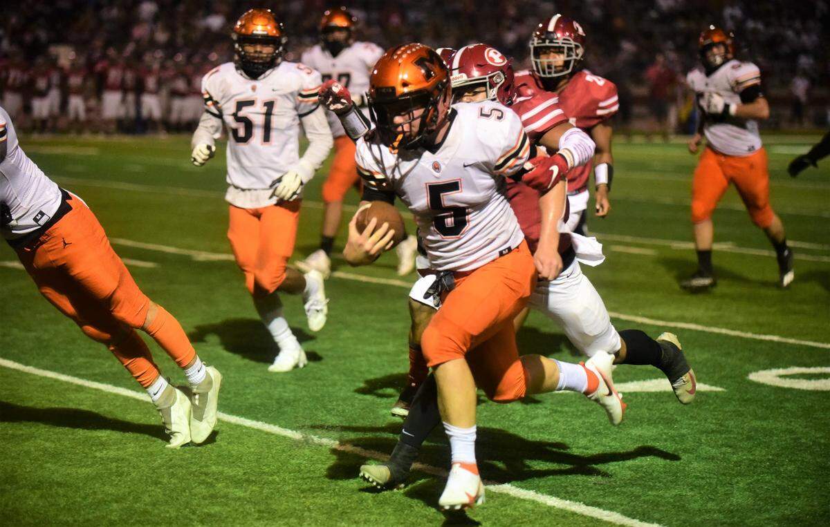 Merced quarterback Seth Scheidt runs the ball during a game against Patterson at Patterson Community Stadium on Friday, Sept. 24, 2021.