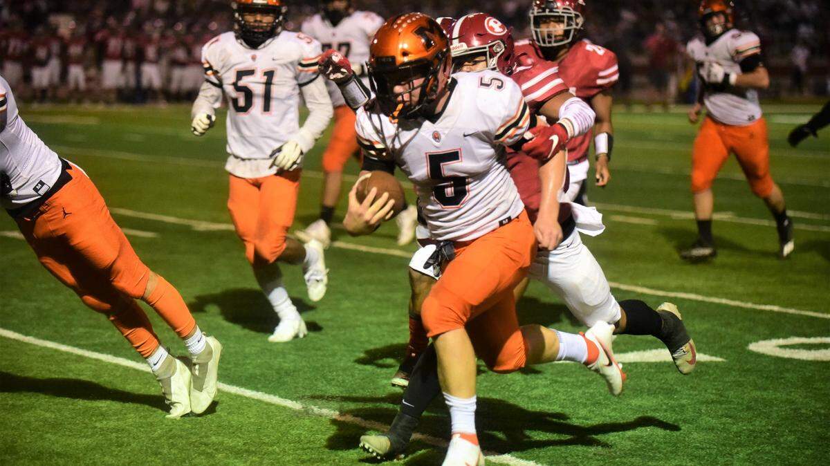 Merced quarterback Seth Scheidt runs the ball during a game against Patterson at Patterson Community Stadium on Friday, Sept. 24, 2021.
